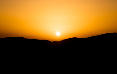 Sunset against the background of mountains