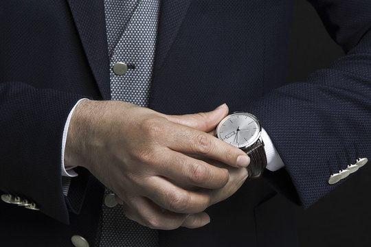 Businessman in office checking the time