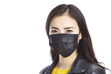 asian woman wearing black mask looking at camera, isolated on white background. 