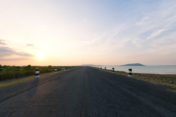 Landscaped walkway around a meadow at sunset sky change from blue to orange,Walkway with stunning views for jogging.