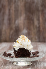Chocolate Cupcake With Vanilla Frosting Missing Bite On Glass Plate