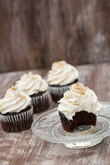 Chocolate Cupcakes With Vanilla Frosting On Glass Plate