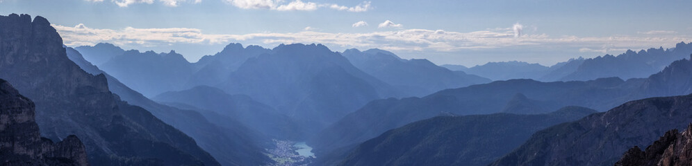 Cadini Valley with the city of Auronzo in the Dolomite Mountains, with blue haze