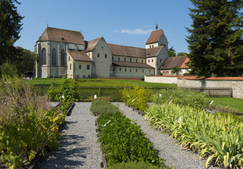 Fototapeta na wymiar Herb garden with St. Maria und Markus Cathedral - Island of Reichenau, Lake Constance, Baden-Wuerttemberg, Germany, Europe