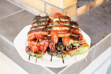 Assorted delicious grilled meat with vegetable over the coals on a barbecue