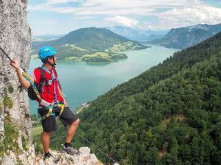 Climber at Mondsee and Attersee, view from Drachenwand rock, via ferrata, Halstatt region, Austria