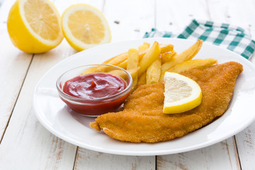 Wiener schnitzel with fried potatoes on white wooden background

