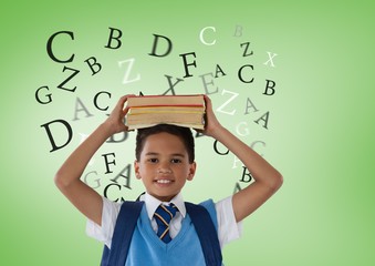 Many letters around Schoolboy holding books in front of green ba