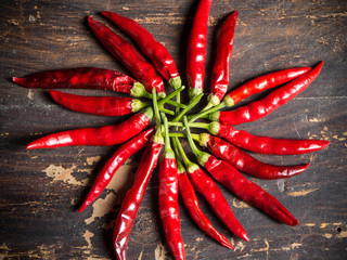 Extra small shili peppers over wooden background