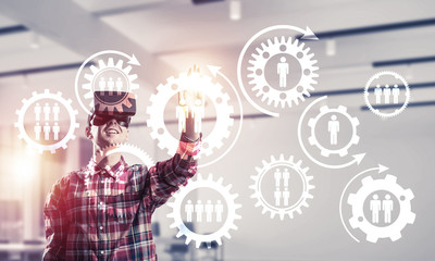 Guy wearing checked shirt and virtual mask demonstrating some em