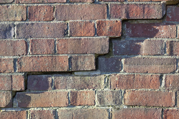 English brickwork in a poor state of disrepair crack algae lichen damp uk