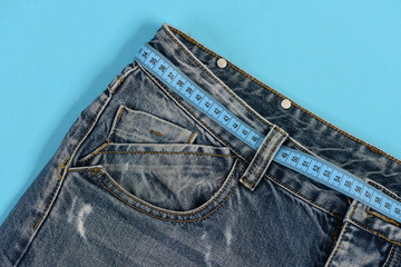 Top part of denim trousers isolated on blue background