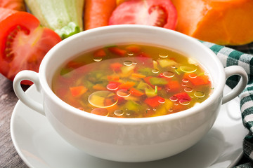 Vegetable soup in bowl on wooden table

