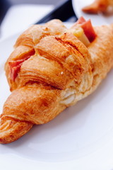 Fresh Croissants on the white plate. Selective focus