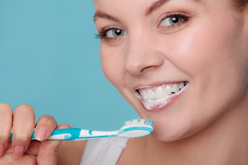 woman with toothbrush brushing cleaning teeth