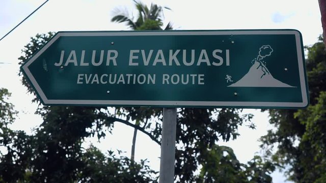 Close up of evacuation route sign near a road to volcano in Ternate, Indonesia. Shot with Sony a7s and Atomos Ninja Flame on cloudy day,