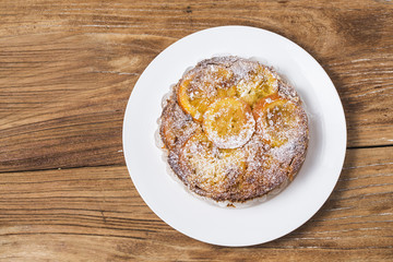 Orange cake on the wooden background