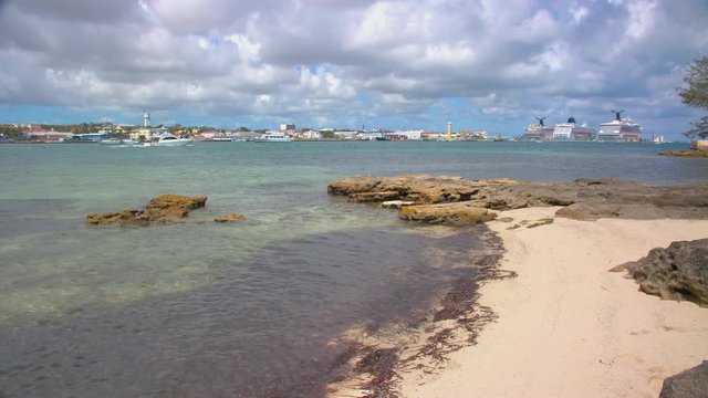 Nassau Bahamas Cruise Port with Visiting Ships Viewed from Casuarina Beach on Paradise Island with Rocks against Pink Sand
