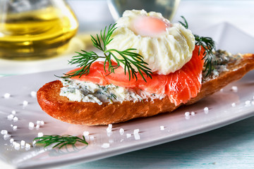 sandwich with ricotta cheese, salmon and poached egg on a plate