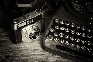 Old vintage retro camera with old-fashioned typewriter