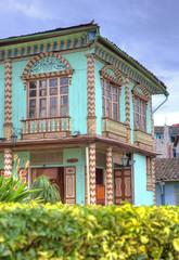 Fototapeta premium Colorful old corner house in the downtown plaza of Zaruma, El Oro, Ecuador