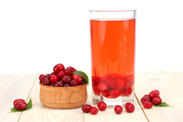 dogwood berries in wooden bowl with dogwood juice on white wooden table