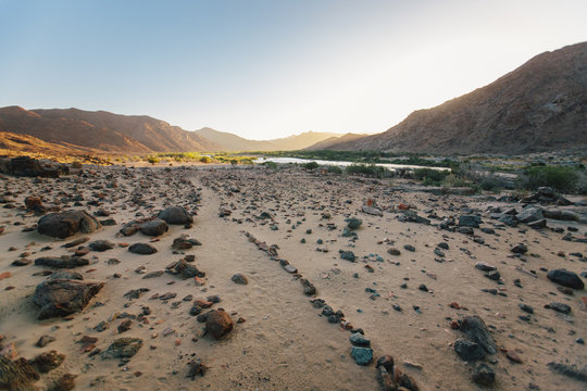 fain path in a scenic desert landscape at dawn