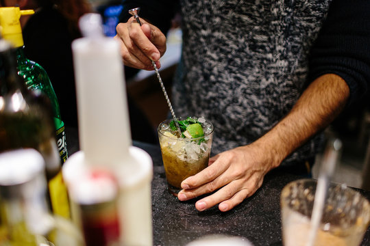 Bartender is making cocktail at bar counter