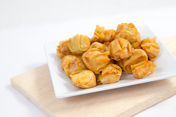 Deep fried wonton or fried dumplings cuisine on white plate