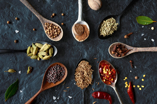 Dried exotic spices on different beautiful spoons