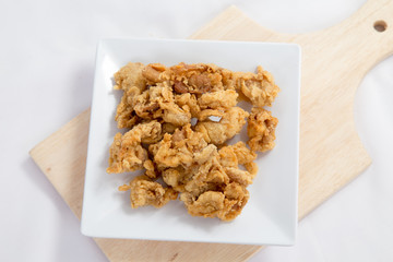 Fried crispy chicken breaded with corn flake crumbs with ketchup on wooden board.