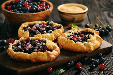 Rustic galettes with blueberries and red currants.