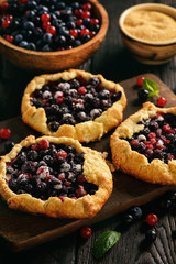 Rustic galettes with blueberries and red currants.