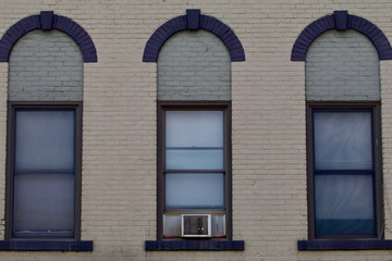 Three windows from a nineteenth century brick building