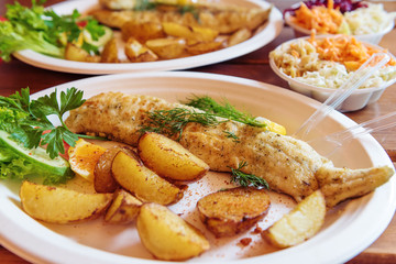 Fish dish - traditional Baltic fried cod fish served with baked potatoes and vegetables.