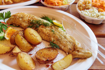 Fish dish - traditional Baltic fried cod fish served with baked potatoes and vegetables.