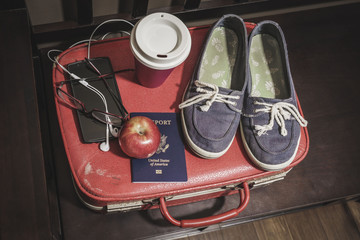 various travel items on a wooden bench