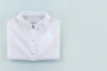 Folded white shirt on white blue with empty space for copy, school or job background