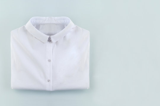 Folded White Shirt On White Blue With Empty Space For Copy, School Or Job Background