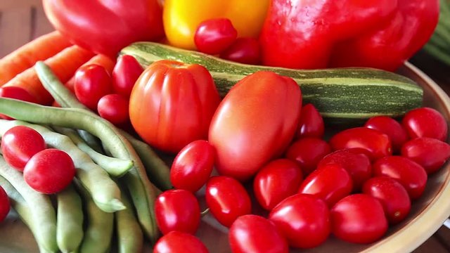Close-up of fresh summer vegetables on turning plate