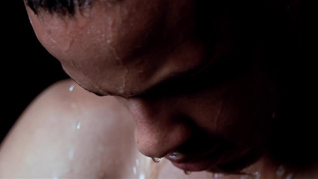 Extreme closeup of Hispanic athlete with water dripping down his face.