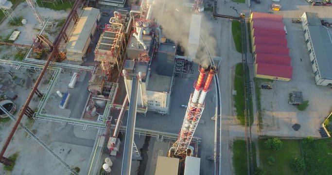Aerial view Oil refinery with a background of mountains and sky at sunset. Aerial footage.