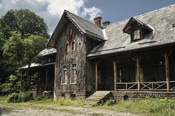 Historic hunting lodge with a facade lined with bark of cork oak in Poland.