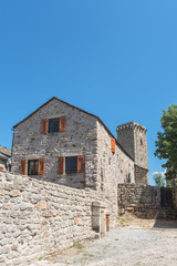 Fototapeta premium La Garde-Guerin, fortified village in Lozere, tower and old house, in the Cevennes in France 