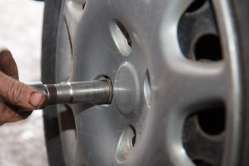 Car mechanic changing tire
