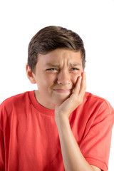 A young teenage boy isolated against white background with tooth ache