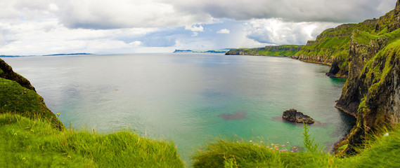 Landscape of Northern Ireland. Cliffs os Carrick-a-rede rope bridge in Ballintoy, Co. Antrim. Traveling through the Causeway Coastal Route.