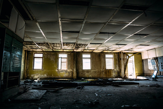 large ruined room with windows, control center room in abandoned factory