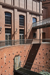 The metal railing and brick wall in an old brewery in Poznan. © GKor