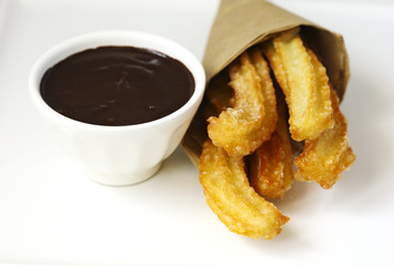 Traditional mexican dessert churros with chocolate sauce